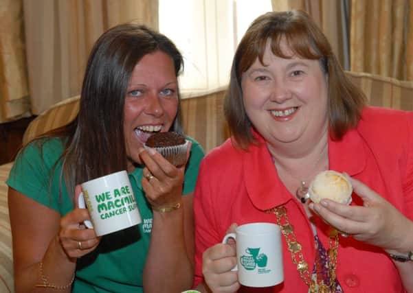 Joanne Young from MacMillan Cancer Support and Larne Mayor Maureen Morrow helping launch the World's Biggest Coffee Morning 2013. INLT 30-341-PR