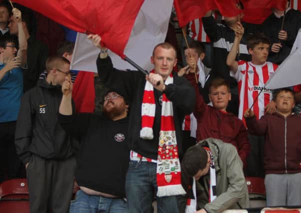 Derry City supporters cheering on their team at last nights European game at the Brandywell.  (Der3113JB087)
