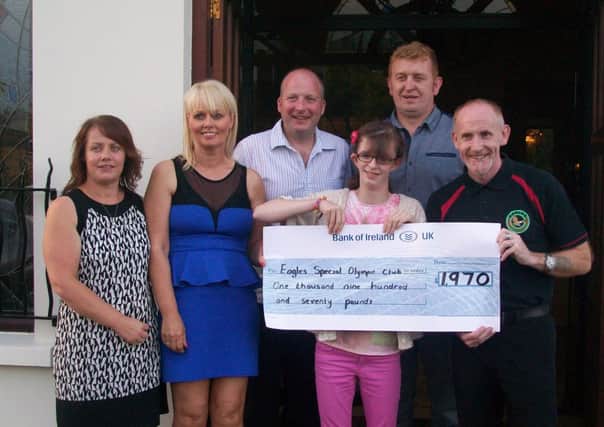 Jackie and Danny O Hagan with Daughter Seorlaith present a cheque to Club Coach Paul Sweeney and Chairman Austin O Neill.