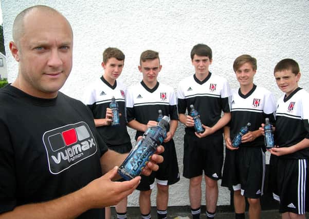 Wakehurst U-17 players photographed with Johnny Hector, Vyomax Drinks; who sponsored the team with drinks during the Foyle Cup. INBT 31-809H