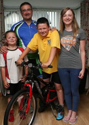 Adam McClung, from Connor, who completed a 20 miles sponsored cycle ride raising money for The Vision of Good Hope Moldova, is pictured with his dad Chris, brother Josh, and Imogen Magee (who is traveling to Moldova). INBT31-210AC