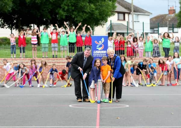 Children playing hockey at Moira with (l-r) Chairman of the Council's Leisure Services Committee, Alderman Paul Porter; Alisa Browne, James Johnston and Mayor, Councillor Margaret Tolerton, as part of Lisburn City Councils summer programme of activities for children 2013.