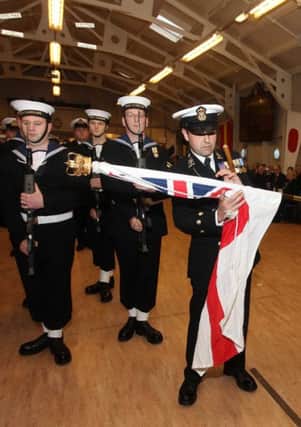 A Royal Navy Reserve colour party with the White Ensign.