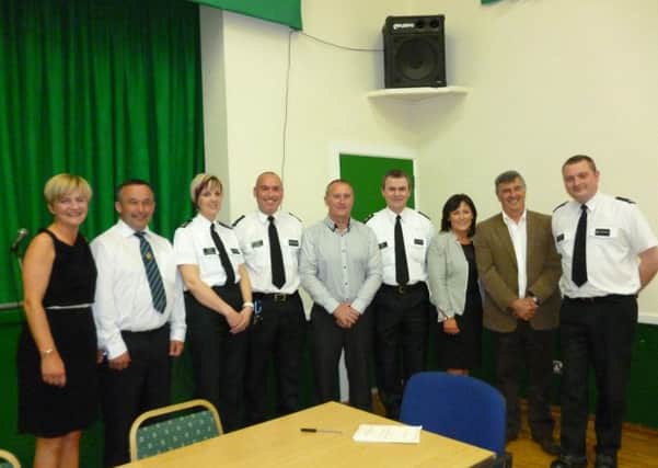 Pictured are officers from Lurgan Neighbourhood Policing Team with representatives from the Management Group of Sarsfield Community Hall at the recent opening of the newly refurbished hall. INLM31 026