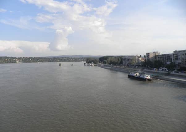 The Danube, facing upstream from the new Petrovaradin bridge in Novi Sad. The pylons of the Old Petrovaradin Bridge are visible. A 200 year old cultural monument, it was blown up by NATO on April 1, 1999. One person was killed.