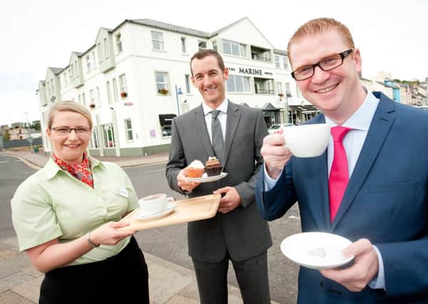 On his first official engagement as newly appointed Finance Minister, Simon Hamilton MLA today visited the reopened Marine Hotel in Ballycastle, which has benefited from the Empty Premises Relief scheme. Photographed with the minister are Catriona Darragh Assistant Food and Beverage Manager and Colum McLornan Director of Marine Hotel Ballycastle Ltd.         Photography Andrew Towe Parkway Photography