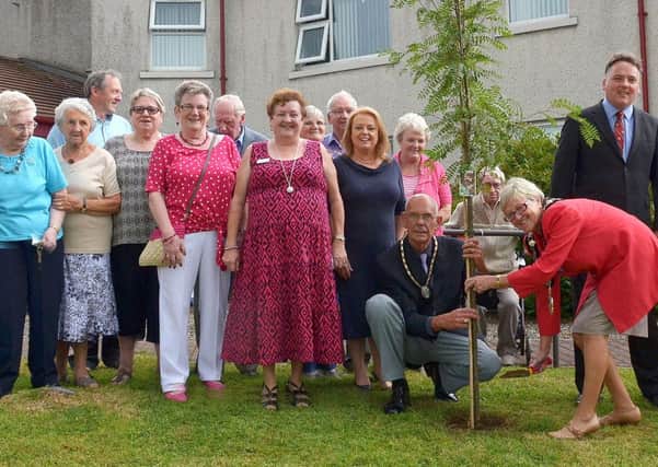 Mayor of Ballymena, Cllr. Audrey Wales assisted by her husband Chris, plant a tree in the garden at Deerfin Fold, to mark the Queen's Golden Jubilee and birth of Prince George. Included are on are Deerfin Fold residents, Committee members, with John McClean (Fold Chief Executive), Eileen Patterson (Fold Director of Housing and Murial Ramsey (Scheme Co-ordinator). INBT 32-211AC