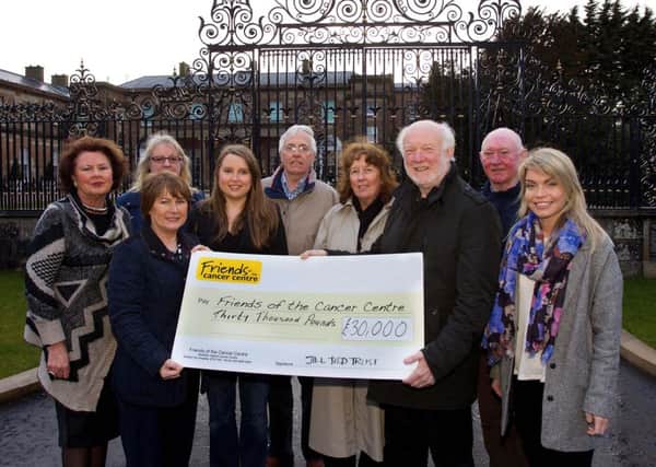 Colleen Shaw (second from left, front), Director of Friends of the Cancer Centre, receives £30,000 from the Jill Todd Trust, which was presented by Barrie Todd (third from left) and representatives of the Jill Todd Trust's committee.