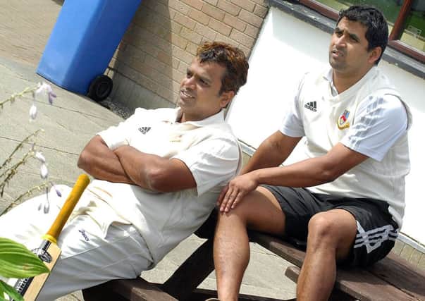 Ballymena cricketers Steve Lazars and Kaushik Aphale watch from the sidelines during their side's innings in Ballymena's weekend defeat by Instonians. INBT 32-927H