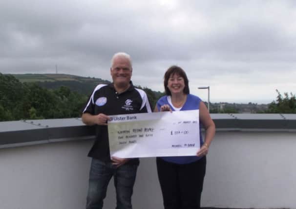 Michael McBrien presents a cheque for £557 to Sharon Gorman of the NI Hospice. INNT 32-610con