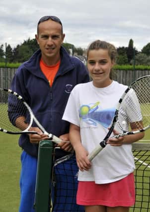 Emma Coalter from Lurgan Tennis Club who has been selected for the Ulster Under 14 squad for the Interprovincial Competition later this month. With her is Ale Iliev, club coach. INLM32-122gc