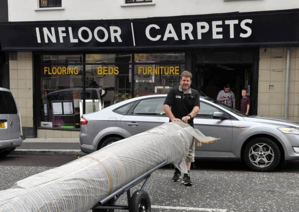 Hold the traffic, Davy Crawford, owner of Infloor Carpets moving stock at his William Street premises. INLM32-128gc