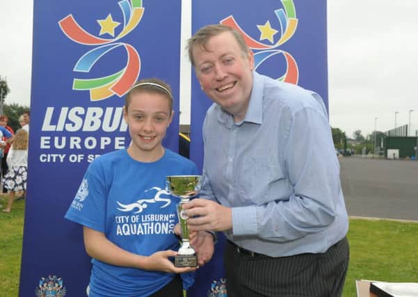 Chairman of the Council's Leisure Services Committee, Alderman Paul Porter presents 1st prize to Lauren Strange, winner of the Female U15 Junior Aquathon.