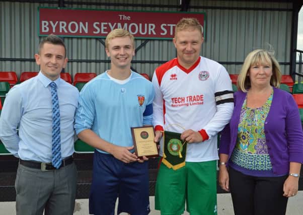 Geraldine Seymour, wife of the late Byron Seymour and son Paul are pictured with PSNI FC captain Peter Steele and Larne Tech Old Boys skipper Robert Hunter at the official opening of the new  Byron Seymour Stand at Dennis Harvey Park.