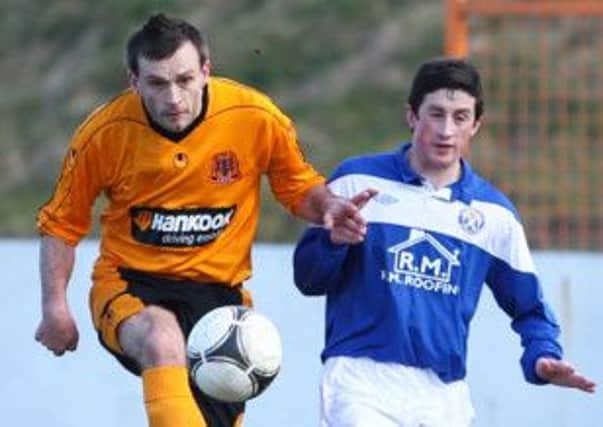 Glenn Taggart (left) has signed a new one-year deal with Carrick Rangers.