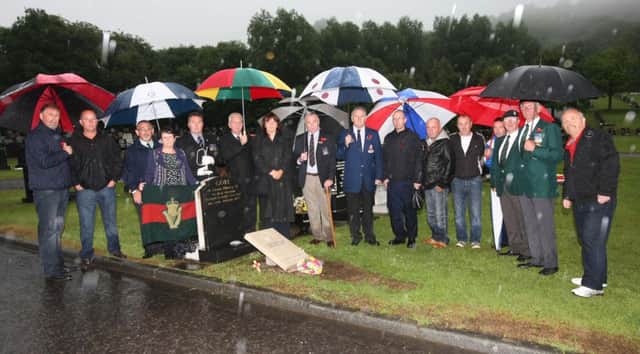Family and friends of Private Alex Gore UDR, who was killed in 1979 in an IRA gun and grenade attack, at his graveside in Carnmoney Cemetery. INNT 32-043-FP