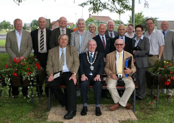 Jon Wheatley and Brendan Mowforth, judges with Britain in Bloom, pictured with Deputy Mayor, Cllr. James McClean, members of the traders association and local volunteers in Ahoghill, where they are judging the "Small Town" category. INBT33-201AC