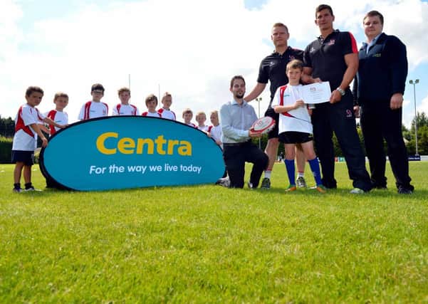 Darragh Armstrong receives his Skills Award from L-R Jonathan Barr, Centra Ballinderry, players Tom Court and Robbie Diack, and Scott Jacques, Centra Ballynahinch Road Lisburn, while other young participants look on.