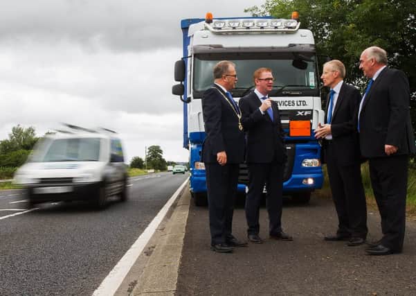 Finance Minister Simon Hamilton discusses the A26 with Gregory Campbell MP, Ian Donaghey, president of Causeway Chamber of Commerce and