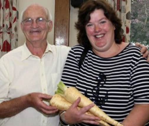 THE MOORE THE MERRIER. Sam Moore hands over some of his home grown parsnips to Paula McIntyre, who was keen to take them home with her.INBM33A-13 018SC.