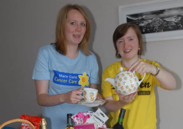 Lucinda White and Astra Scott get ready for their Marie Curie Tea party which will be held in Lisburn Racquets Club on Saturday 17th August from 10am.
