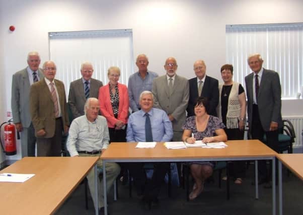Chairman Bill Adamson and colleagues at the AGM of Carrickfergus Enterprise. INCT 33-633-CON
