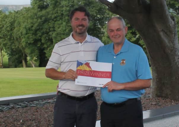 Cairndhu Golf Club Professional Mr Stephen Hood (left) presents Mr Tony Watts (right) with his prize of a return trip with P&O Irish Sea as winner of Larne Youth's Golf day.