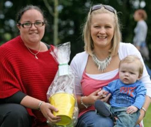 JUST BONNY. Mum Leanne McAfee (right), pictured with her little boy Joey who won a Bonny Baby competition at Castle Community Association's Fun Day. Included is Cllr Roma McAfee, who presented the award.INBM33A-13 054SC.
