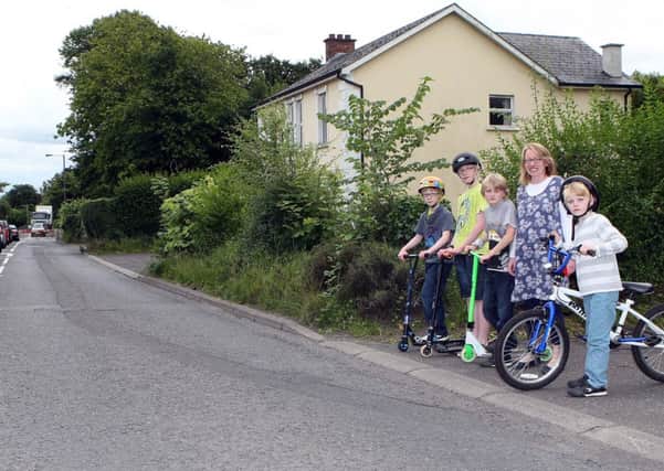 Margaret McCreedy with her sons Joshua and Matthew with Kellen and Lowell Finlay on the stretch of the Jordanstown Road where a new footpath is to be built. INNT 34-013-FP