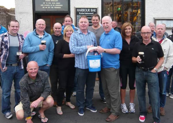 Geoff Vogan presents Milne Rowntree with a donation for Willies Orphan Fund on Friday evening, in Portrush. The donation of over £200 was made during a charity cycle ride from Portadown to Portrush and back again. Chest Heart and Stroke was the main beneficiary for the event. INCR33-153S