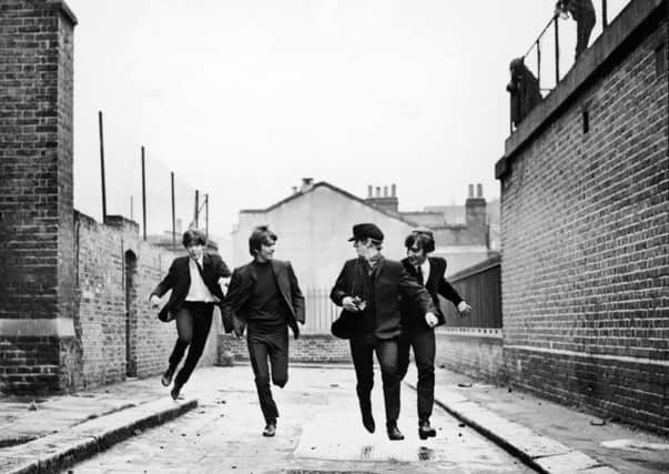 British rock group The Beatles run down an alley in a still from the film, 'A Hard Day's Night,' directed by Richard Lester, 1964. L-R: Paul McCartney, George Harrison, Ringo Starr and John Lennon. (Photo by United Artists/Courtesy of Getty Images)