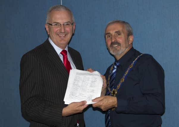 Regional Development Minister Danny Kennedy recieves a petition from SDLP Councillor Gerry Mullan, Mayor of Limavady