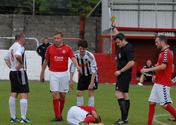 Larne's Scotty Irvine is grounded after this Dergview foul. INLT 33-362-PR