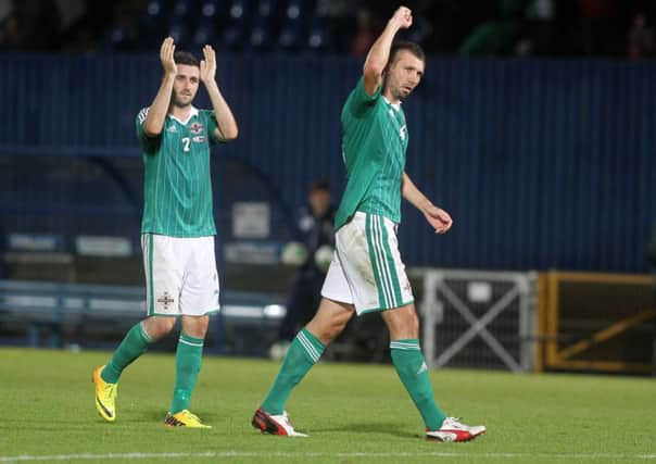 Northern Ireland's Daniel Lafferty (left) and Gareth McAuley celebrate at the end of the match after beating Russia 1-0, at Windsor Park.