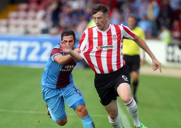 Derry City defender Shane McEleney is pulled back by Trabzonspor's Zeki Yavru, during their recent Europa League tie, at the Brandywell.