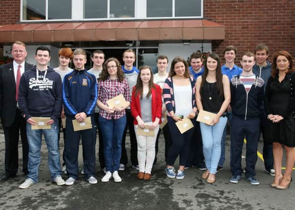 Students from St. Louis Grammar School who received three A's or more in their As level exams are pictured with Mrs. J. O'Neill (head of year) and Mr. G. White (vice-principal). INBT34-217AC