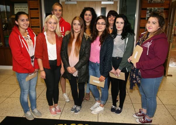 Dunclug College students who were some of the top achievers in A Level and AS Level. Included is Mrs. J. Tuff (head of sixth form). INBT34-212AC