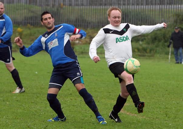 Waveney Swifts captain Gary Boyd puts pressure on Shore Wanderers player Willie Brown. INBT34-241AC