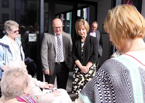 Fionnuala McAndrew meets with some of the staff an residents of Thackeray Care who protested against its closure, outside the Roe Valley arts Centre on Monday morning. INLV3213-367KDR