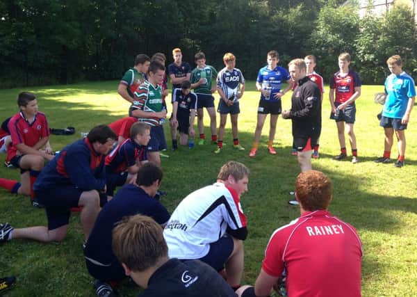 Ulster's Fitness Development Officer Robbie Bremner offers advice to the Ballyclare HS players. INLT 35-903-CON