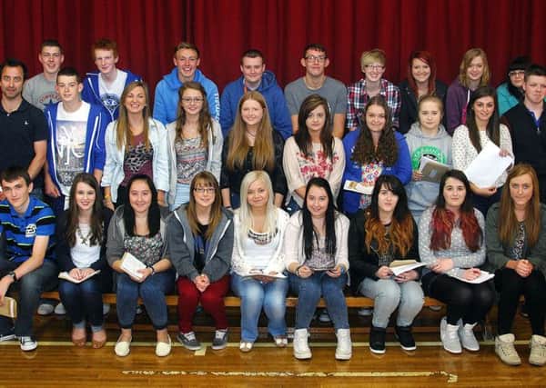 Dunclug College staff member Mr Crookes joins pupils who received high grades in their recent GCSE examinations. INBT 35-802H