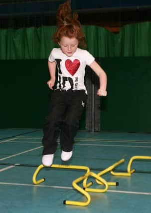 Erin Fleck jumps over the obstacles during one of the events at the multi sports week at the Seven Towers Leisure Centre. INBT34-220AC