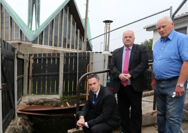 Paul Frew MLA and Cllr Martin Clarke with local resident Trevor Robinson at his neighbour's house on the Larne Road which has been contaminated with heating oil for the second time in a matter of months. INBT 35-100JC