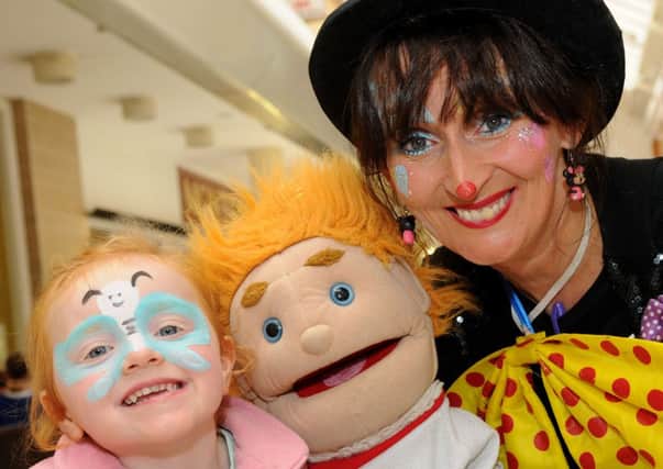 Smiling faces at the kids "Back to School" fun day held at Meadowlane Shopping Centre last Friday. They are Olivia and Curley the Clown from BM promotions.INMM3513-367SR
