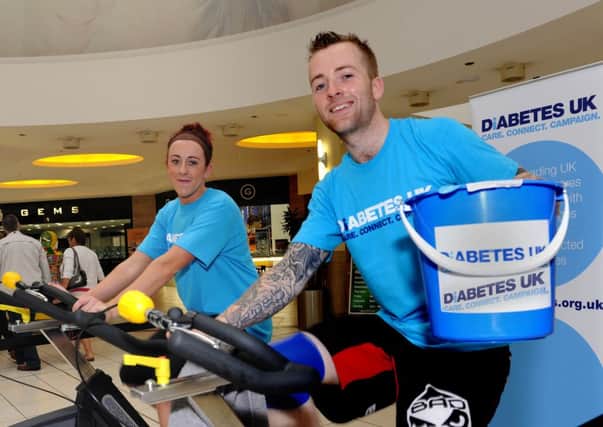 Magherafelt man Niall Fleming is joined by Emma Quinn, when he staged a 'Spin-a-thon' at Meadowlane Shopping Centre, Magherafelt to raise funds and awareness for Diabetes UK. INMM3513-140ar.