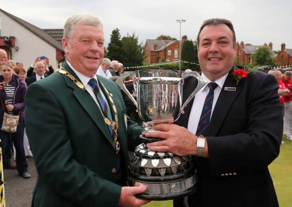 IBA President Ronnie Blaire presents the Junior Cup to Ballymena captain Ivan Lynn after his team's win over Downpatrick in the final of the IBA Junior Cup at Belmont. Picture: John McIlwaine/Press Eye
