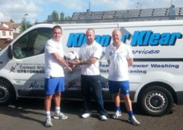Willie Rainey, of Klean "n" Klear Cleaning services, preents a sponsored match ball to Southside Youths officials Tony Corrigan and Robin McIlhagga.