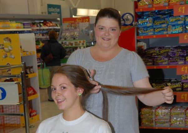 Kirsty Warren gets ready to lose her locks in ASDA to raise money for PIPS. INLT 35-398-PR