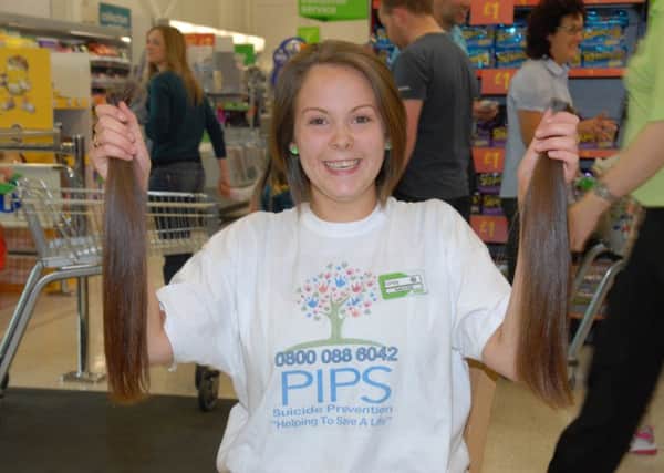ASDA's Kirsty Warren with her pigtails cut off to raise money for PIPS. INLT 35-399-PR