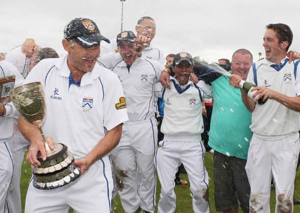 Coleraine skipper David Cooke (left) gets the champagne treatment after they clinched the North West Premier Division title, following their win over Brigade, on Sunday. PICTURE MARK JAMIESON
